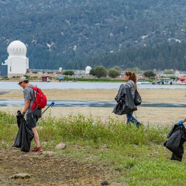 Volunteers collect trash from the shoreline of Big Bear Lake during a Care For Big Bear clean up event.