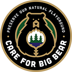 A circular digital logo of the Care For Big Bear movement, stating to preserve our natural playground.