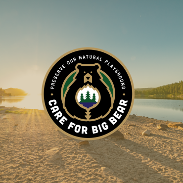 A circular digital logo of the Care For Big Bear movement, stating to preserve our natural playground with a lake backdrop.