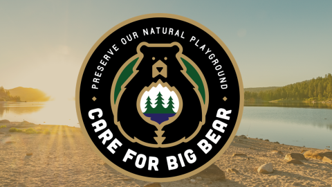 A circular digital logo of the Care For Big Bear movement, stating to preserve our natural playground with a lake backdrop.
