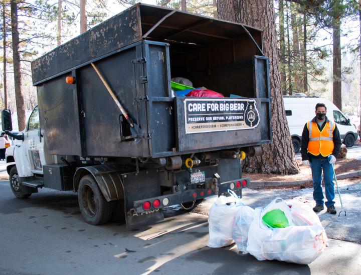NativeScapes partners with Care For Big Bear to haul away bags of trash from a picnic area.