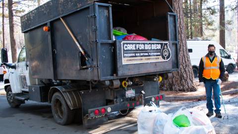 NativeScapes partners with Care For Big Bear to haul away bags of trash from a picnic area.