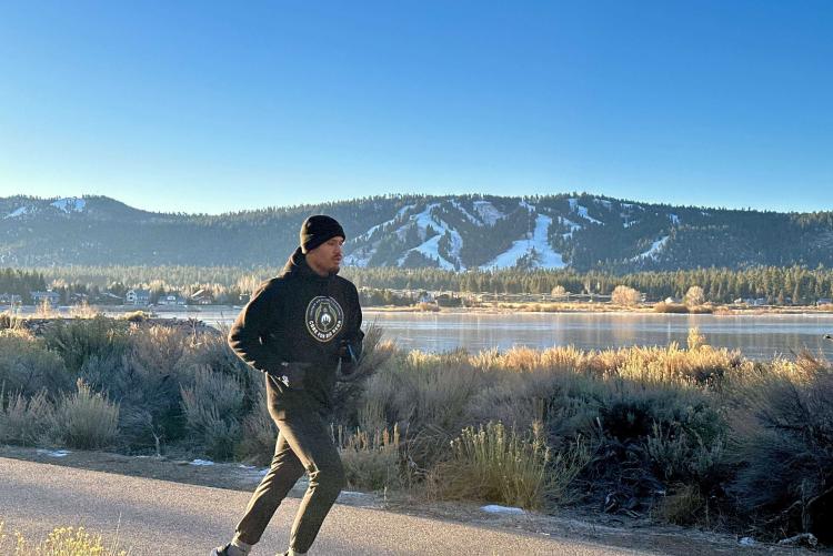 Professional boxer Ronaldo Mancilla jogs along a Big Bear highway during a scenic training session against the snowy mountain