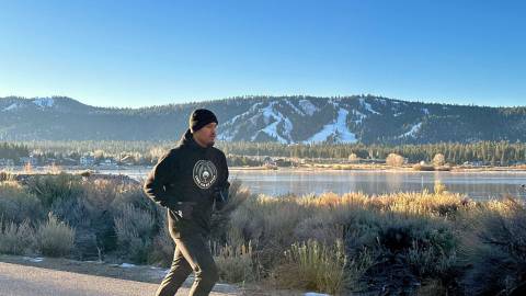 Professional boxer Ronaldo Mancilla jogs along a Big Bear highway during a scenic training session against the snowy mountain