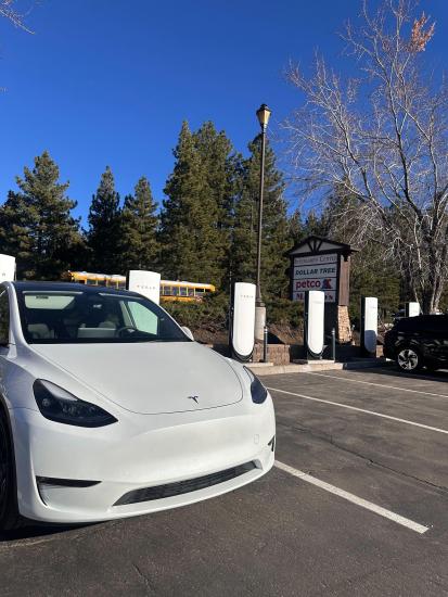 A photo of a Tesla parked in an electric vehicle parking space in Big Bear - the chargers are by Tesla and are non-exclusive.
