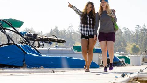 Two women walk along a Big Bear dock