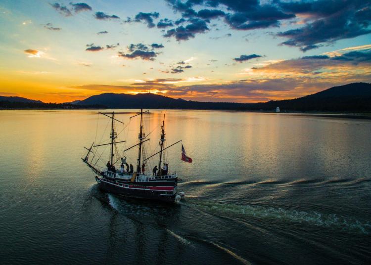 The Big Bear Pirate Ship cruising Big Bear Lake at sunset