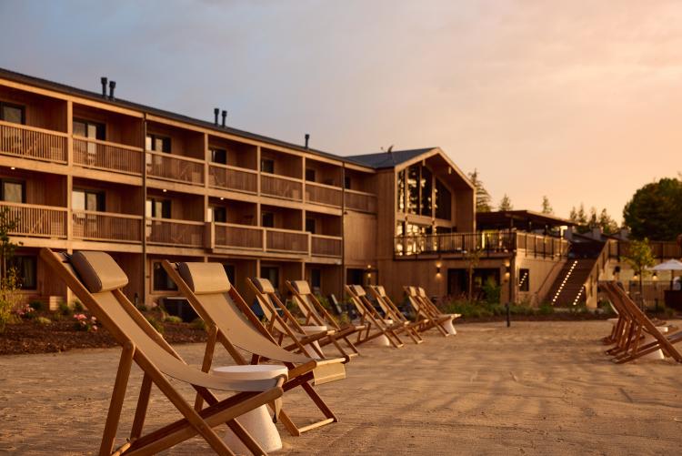 A photo of Marina Riviera in Big Bear Lake California, there is a sunset gently illuminating the hotel.