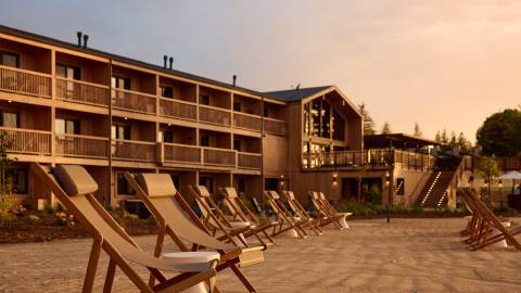 A photo of Marina Riviera in Big Bear Lake California, there is a sunset gently illuminating the hotel.