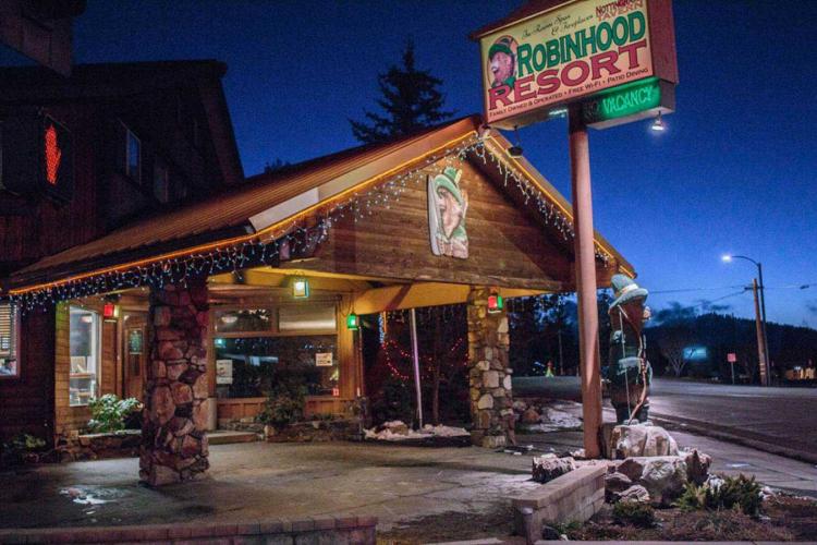 A photo of the Robinhood Resort building's entrance during night - festive lights are strung across the roof.
