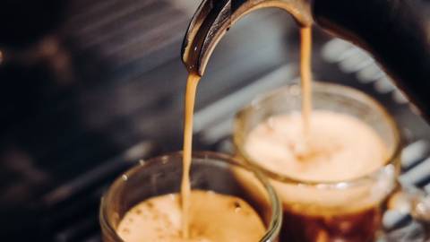 A photo of an espresso being brewed, it is flowing into two glasses from a split pour attachment at Moonridge Coffee Company.