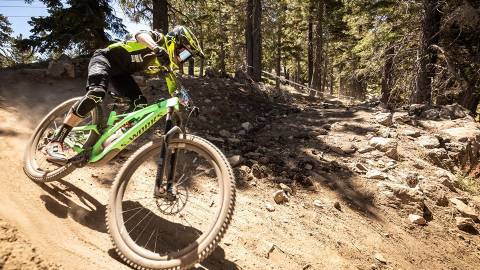 A photo of a bike racer going down a hill during the Monster Energy Pro Downhill event at Big Bear Mountain Resort.