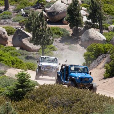 Jeeps drive along a fire road on a Spring off-roading adventure through Big Bear Lake, CA