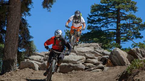 Mountain bikers speed down the Snow Summit Bike Park