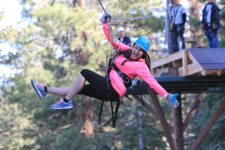 A woman speeds by on a zipline