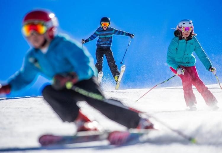 Kids descend the winter ski slopes in Big Bear