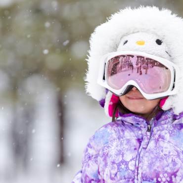 A little girl enjoys the snowy winter