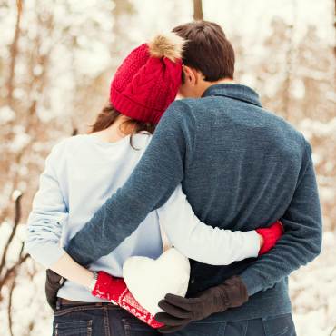 couple holds a heart snowball in Big Bear, CA