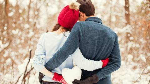 couple holds a heart snowball in Big Bear, CA