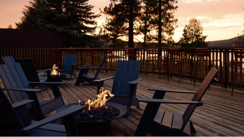 Fire pit lounge deck at Hotel Marina Riviera in Big Bear Lake during a scenic sunset