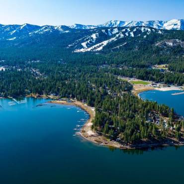 A photo of Big Bear Lake, the snow covered mountains visible in the far distance.