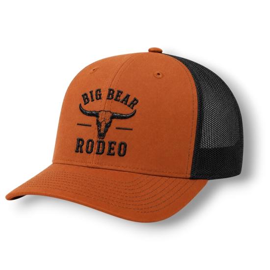 An orange rodeo hat sold during the Big Bear Lake Rodeo - it has a longhorn animal decal with "Big Bear Rodeo" underneath.