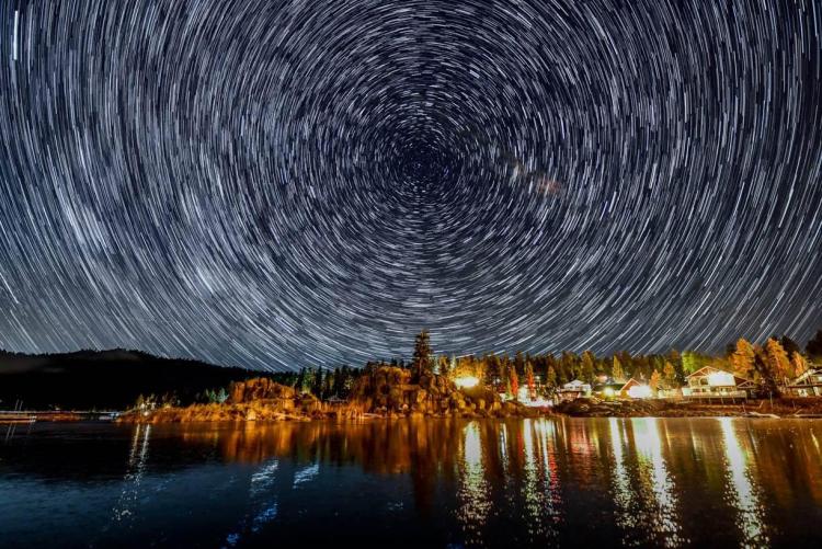 A timelapse of stars circle in the night sky over Boulder Bay in Big Bear Lake, CA.