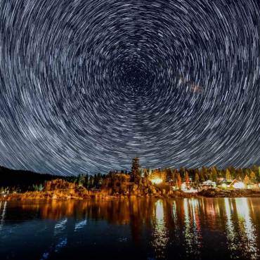 A timelapse of stars circle in the night sky over Boulder Bay in Big Bear Lake, CA.