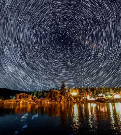 A timelapse of stars circle in the night sky over Boulder Bay in Big Bear Lake, CA.