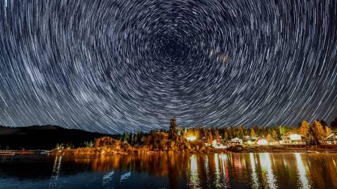 A timelapse of stars circle in the night sky over Boulder Bay in Big Bear Lake, CA.