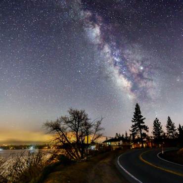 A photo of Big Bear's beautiful night sky, the bright stars and a galaxy are visible.