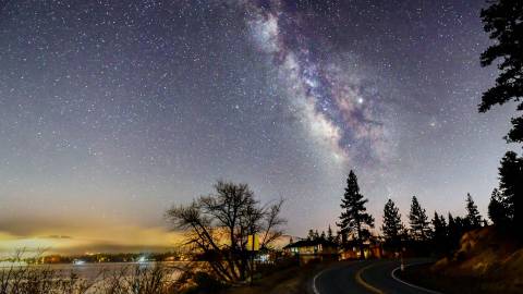 A photo of Big Bear's beautiful night sky, the bright stars and a galaxy are visible.