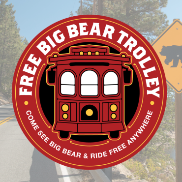 A digital logo for the Free Big Bear Trolley, there is a graphic of a red trolley with three arched windows on the front.