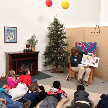 A photo of Mountain Story Time at the Big Bear Discovery Center - there are children gathered listening to a story read aloud