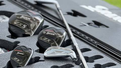 A photo of golf clubs ranging in size within a foam case, one golf club is laid ontop of the rest.