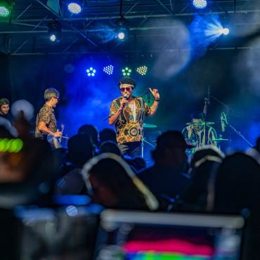 A photo taken from the Big Bear Summer Concert Series -  the band on stage is playing in front of a large crowd.