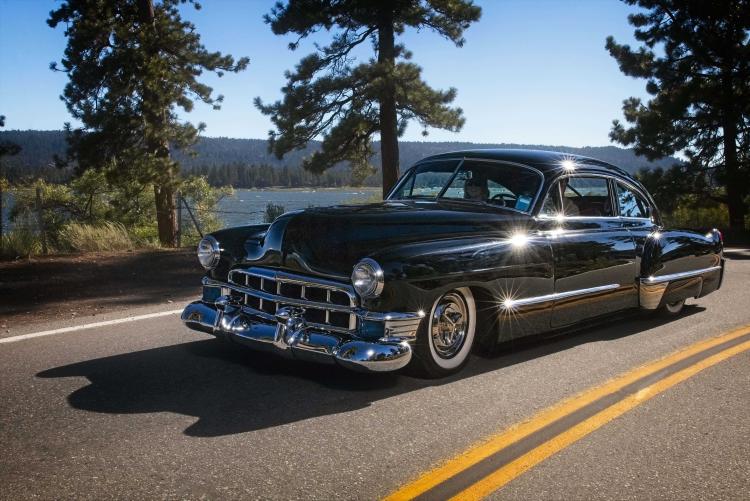 Antique car driving near the lake