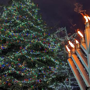 Big Bear's Grand Menorah shines brightly next to The Village Christmas Tree in Big Bear Lake this holiday season.