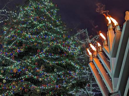 Big Bear's Grand Menorah shines brightly next to The Village Christmas Tree in Big Bear Lake this holiday season.