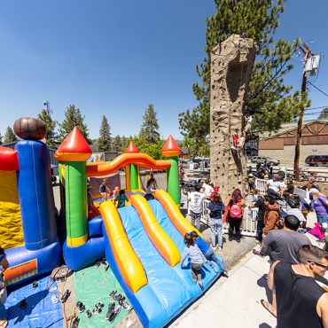 Bounce house and climbing wall at Memorial Weekend festival
