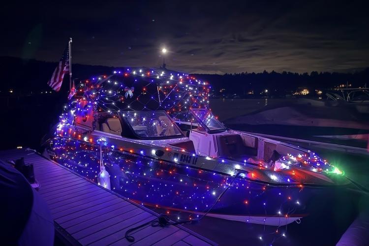 Second place boat display during the 2026 Parade Of Lights - the boat is covered in string lights seen in a net like pattern.