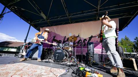 An upward angle photo taken ontop of the LakeFest live music stage, the two males onstage are holding guitars