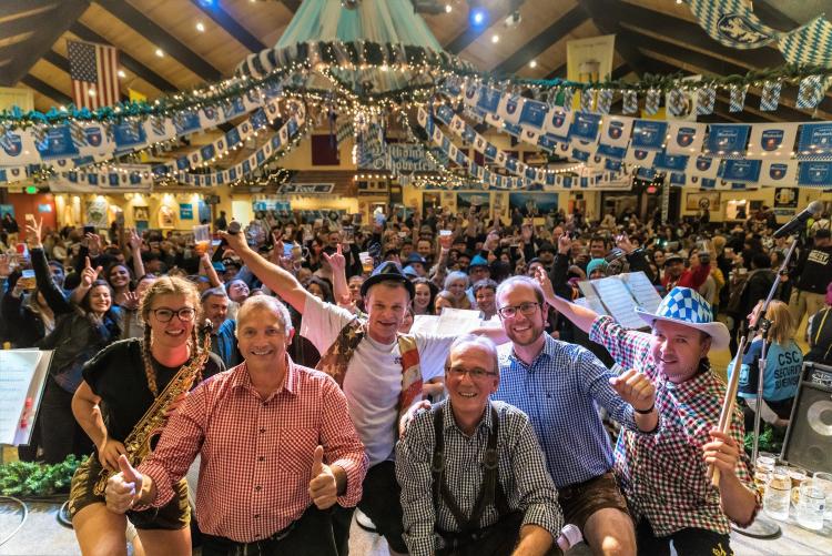 A large group of Oktoberfest goers wave to the camera at the Big Bear Lake Oktoberfest.