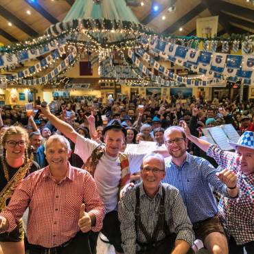 A large group of Oktoberfest goers wave to the camera at the Big Bear Lake Oktoberfest.