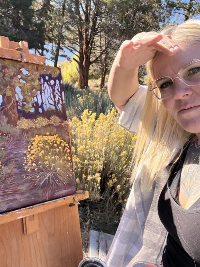 An artist's social upload of their painting during the Plein Air competition, her painting depicts vibrant yellow wildflowers