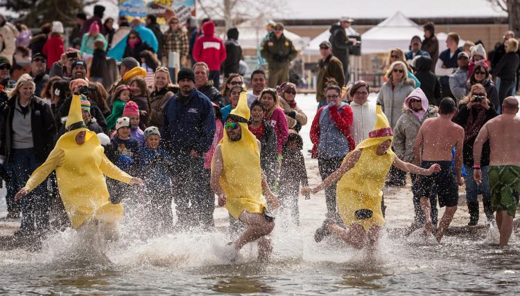 A team wearing banana costumes runs into the water at the Polar Plunge in Big Bear