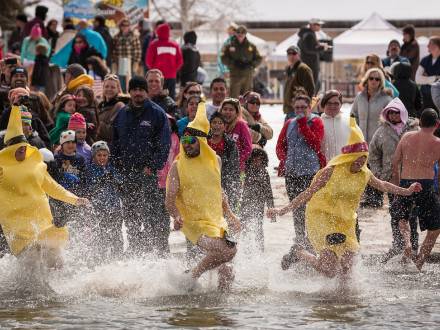 A team wearing banana costumes runs into the water at the Polar Plunge in Big Bear