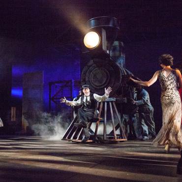 A theatre performance of Stoneface by the Big Bear Theatre Project - there is a man resting on the front of a steam train.