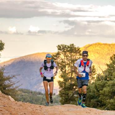 Two runners jog up a trail during the Kodiak 100 race in Big Bear Lake.
