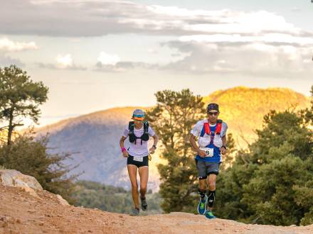 Two runners jog up a trail during the Kodiak 100 race in Big Bear Lake.